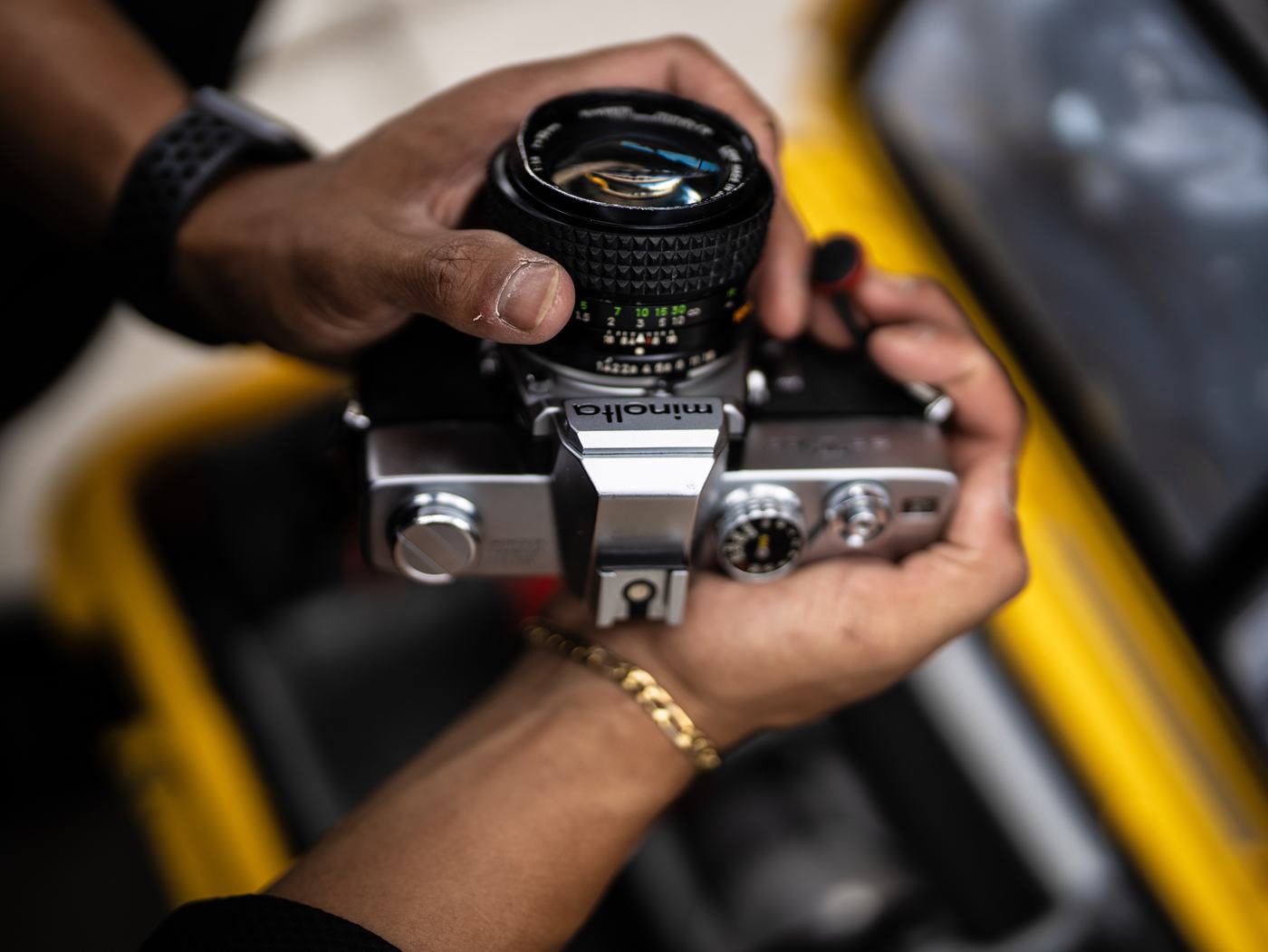 Close-up of hands holding a vintage film camera